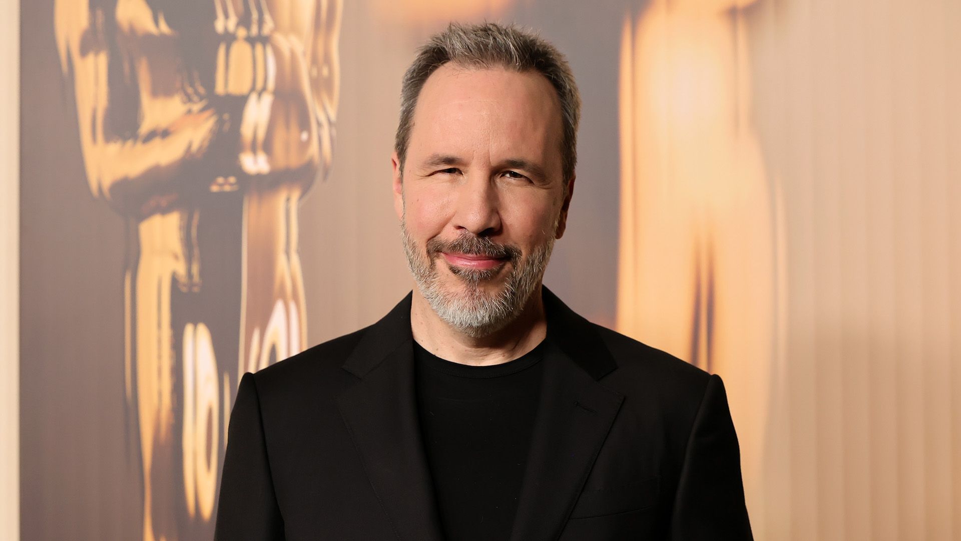 Regizorul Denis Villeneuve într-un tricou negru și un blazer negru